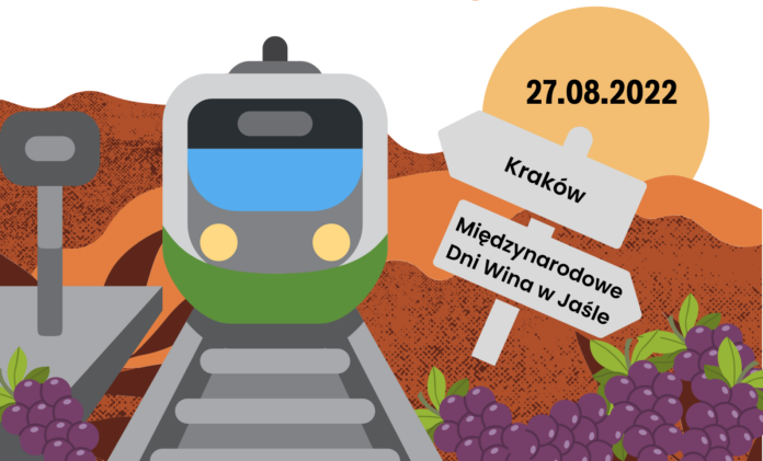 pociąg na torach, po rawej stronie na tablicze data 27 sierpnia i napisy Kraków oraz MIedzynarodowe Dni Wina w Jaślee